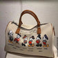 Bolsa de ombro temática Mickey: uma jornada pelo mundo